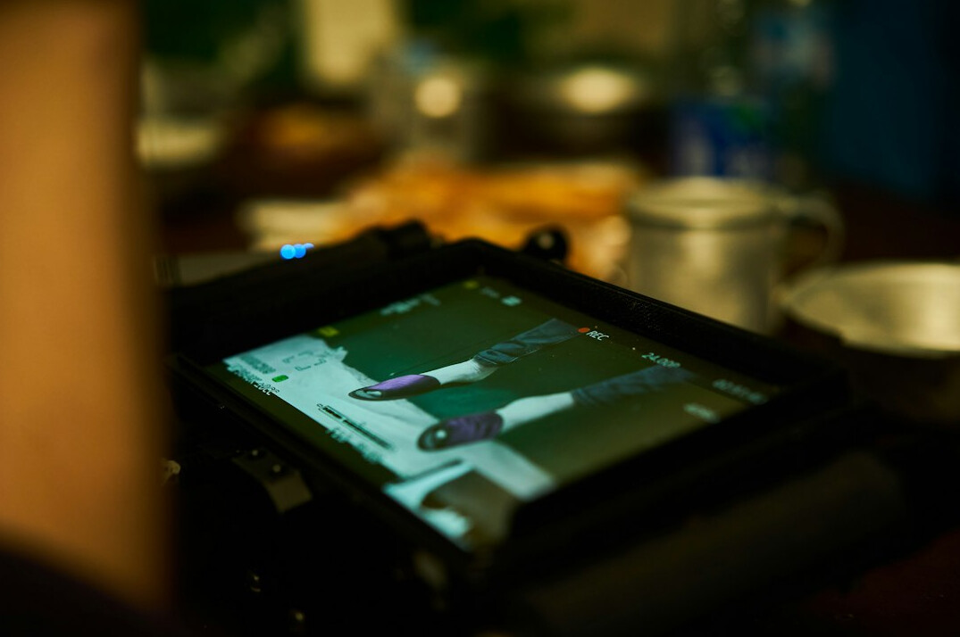Filmmaker reviewing footage clips on a light table style monitor array